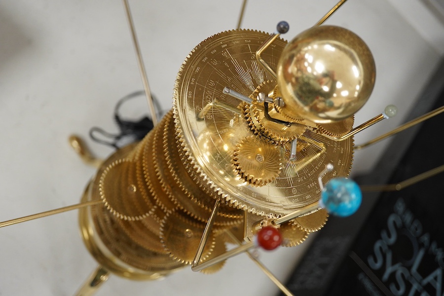 A precision brass orrery, a kit built electric operated astronomical orrery issued by Eaglemoss Publications as a part work ‘Build a Model Solar System’, complete with hardstone planets, brass moons, and a complete run o